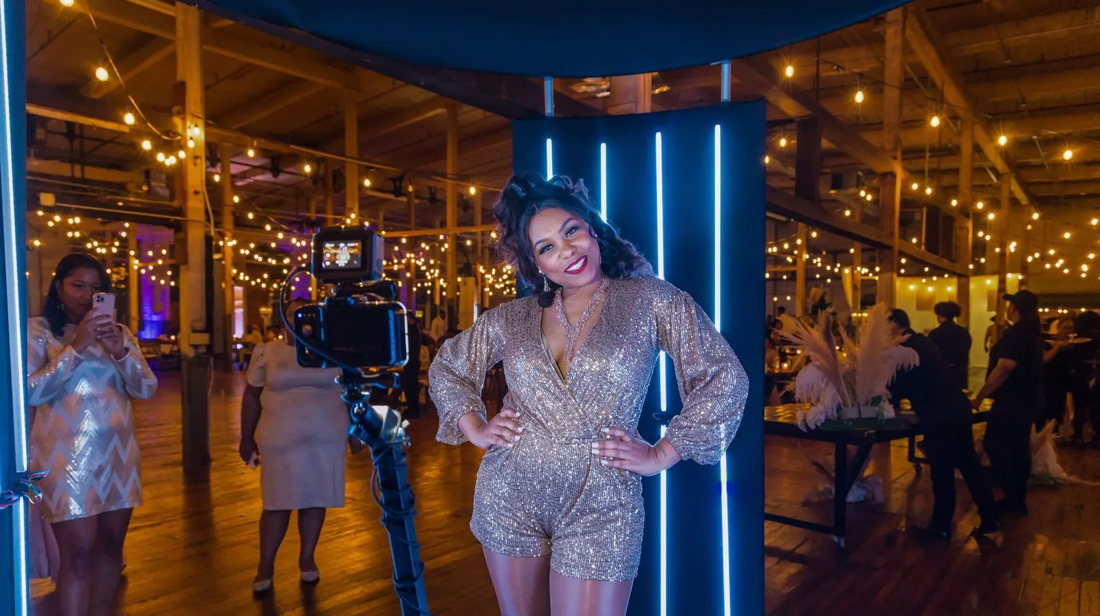 Guests on a lit 360 photo booth platform at an event