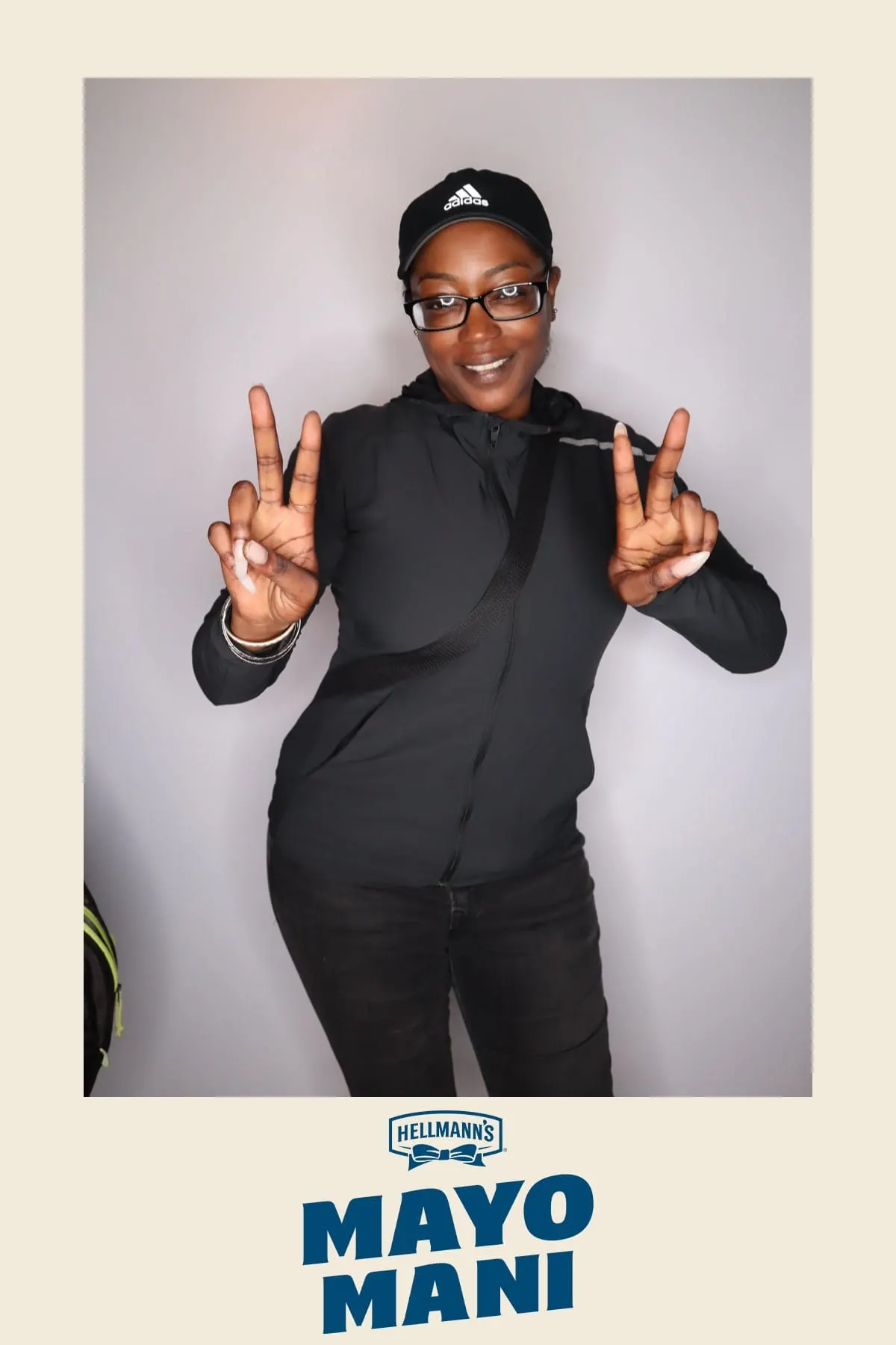 Guest in an Adidas cap throwing up peace signs at the Hellmann's Mayo Mani activation
